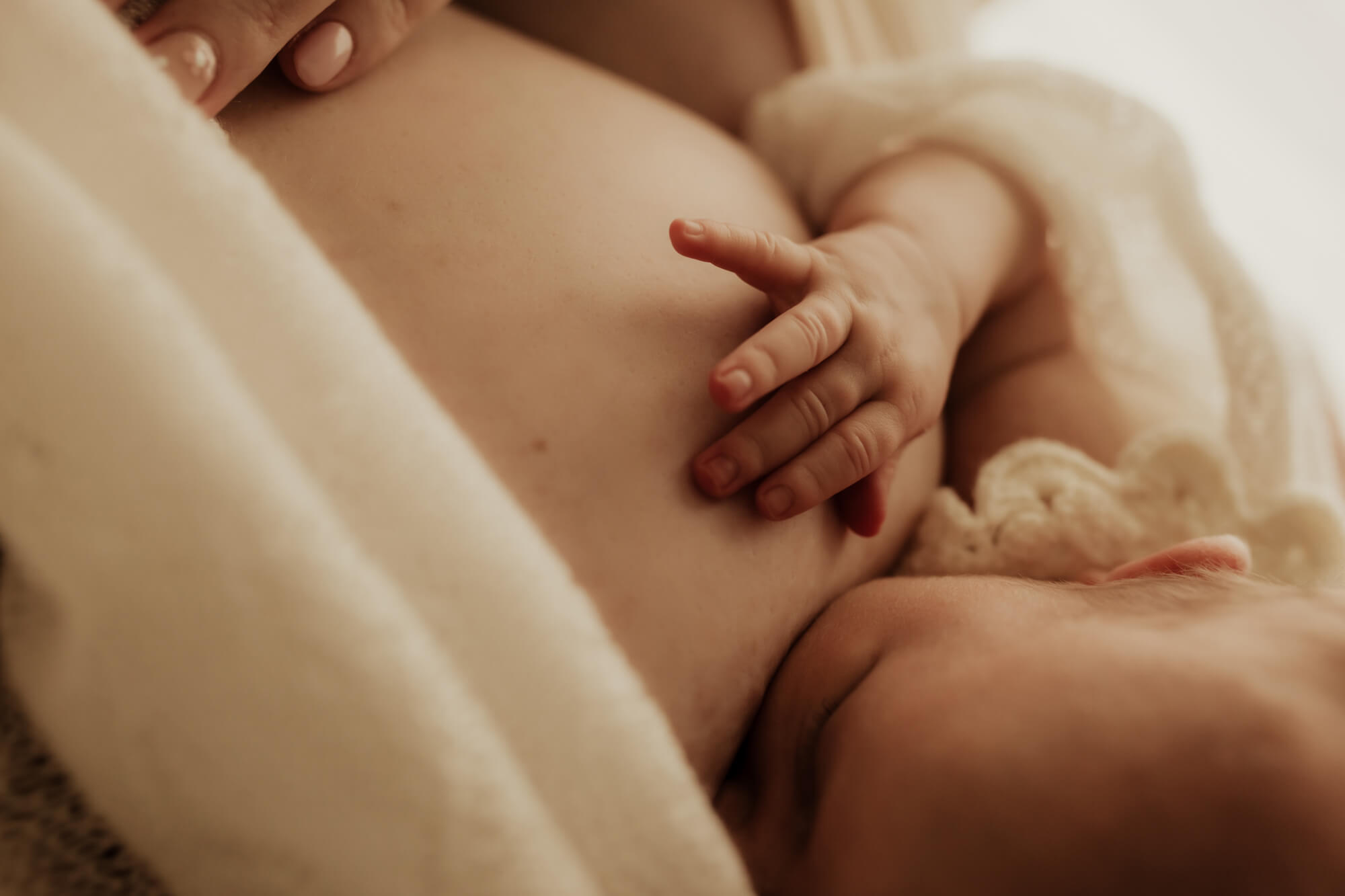 Details of a newborn baby breastfeeding