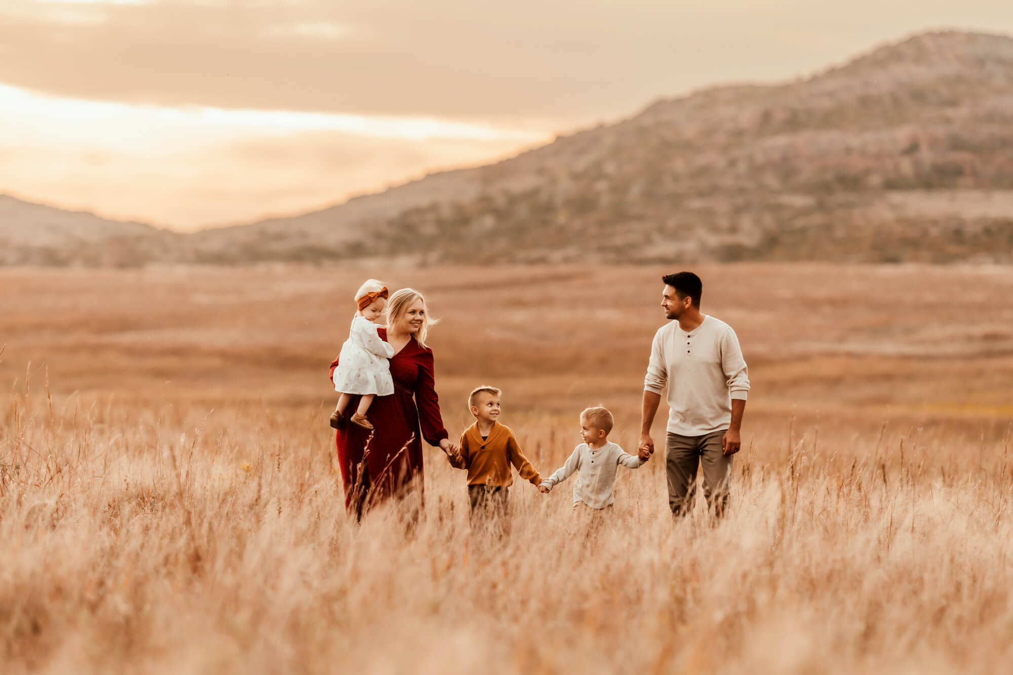 Family portrait session with a golden field near sunset.