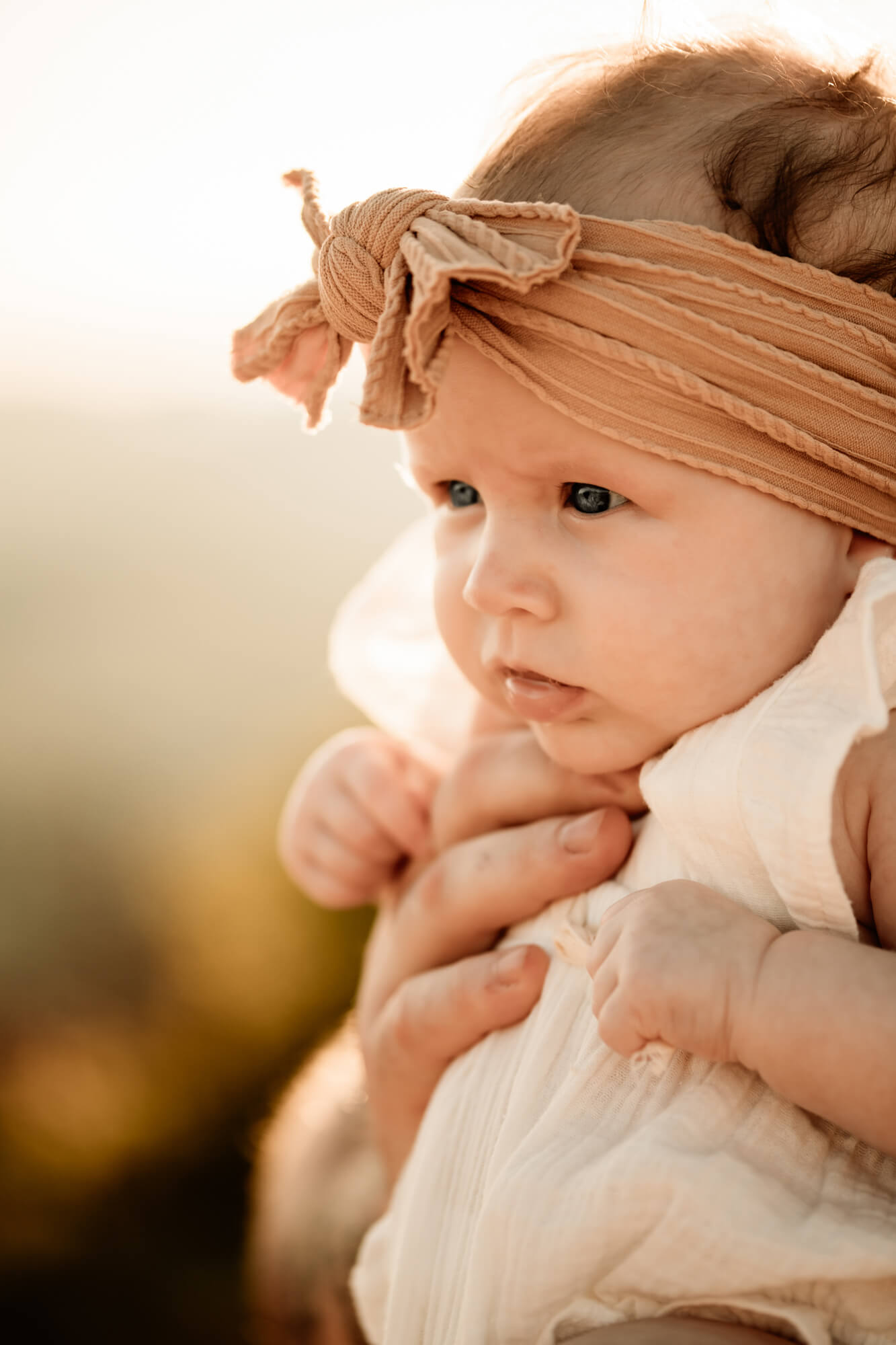 Baby girl wearing a yellow headband.