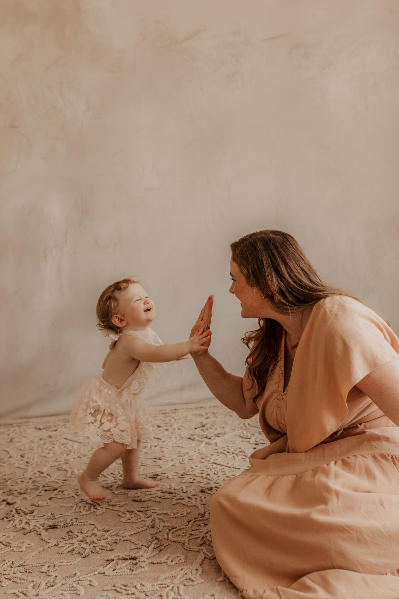 One year old baby girl gives her mother a high five, Oklahoma Science Museum.