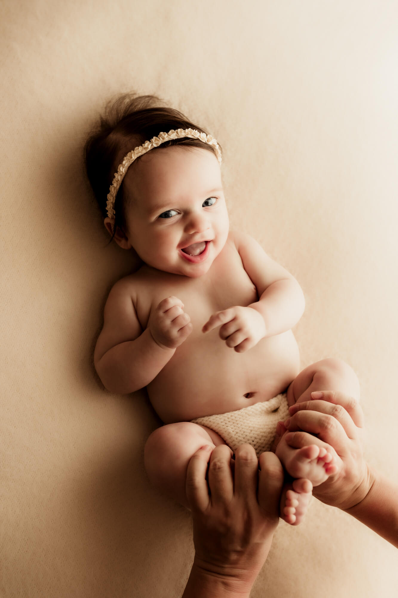 Baby girl smiles while laying down, OU Children's Hospital