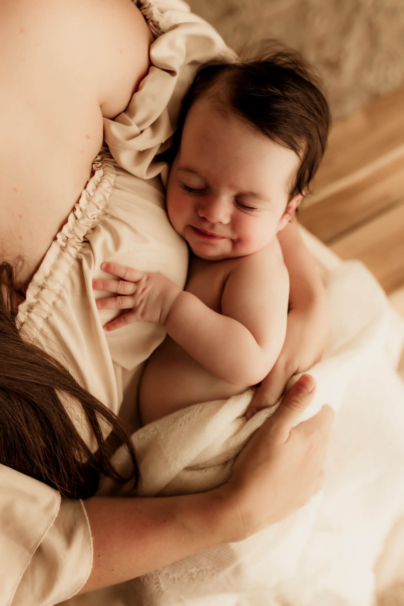 Baby girl sleeps in her mother's arms, OU Children's Hospital