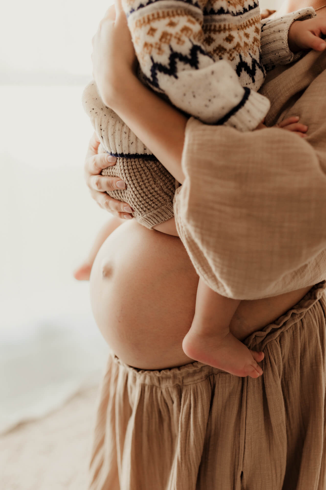 Pregnant mother holds her son, birthing center okc.