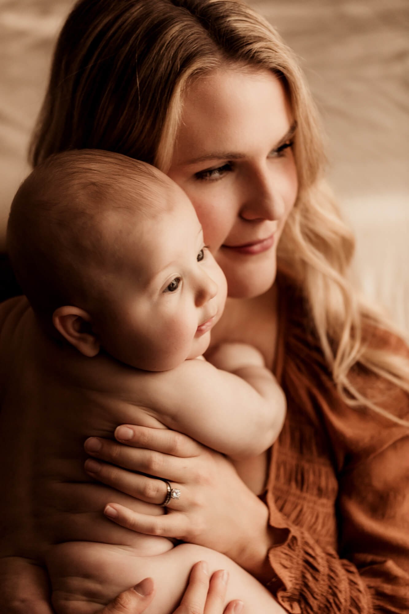 Mother holds her son as they look away from the camera,Peek-A-Boo Baby