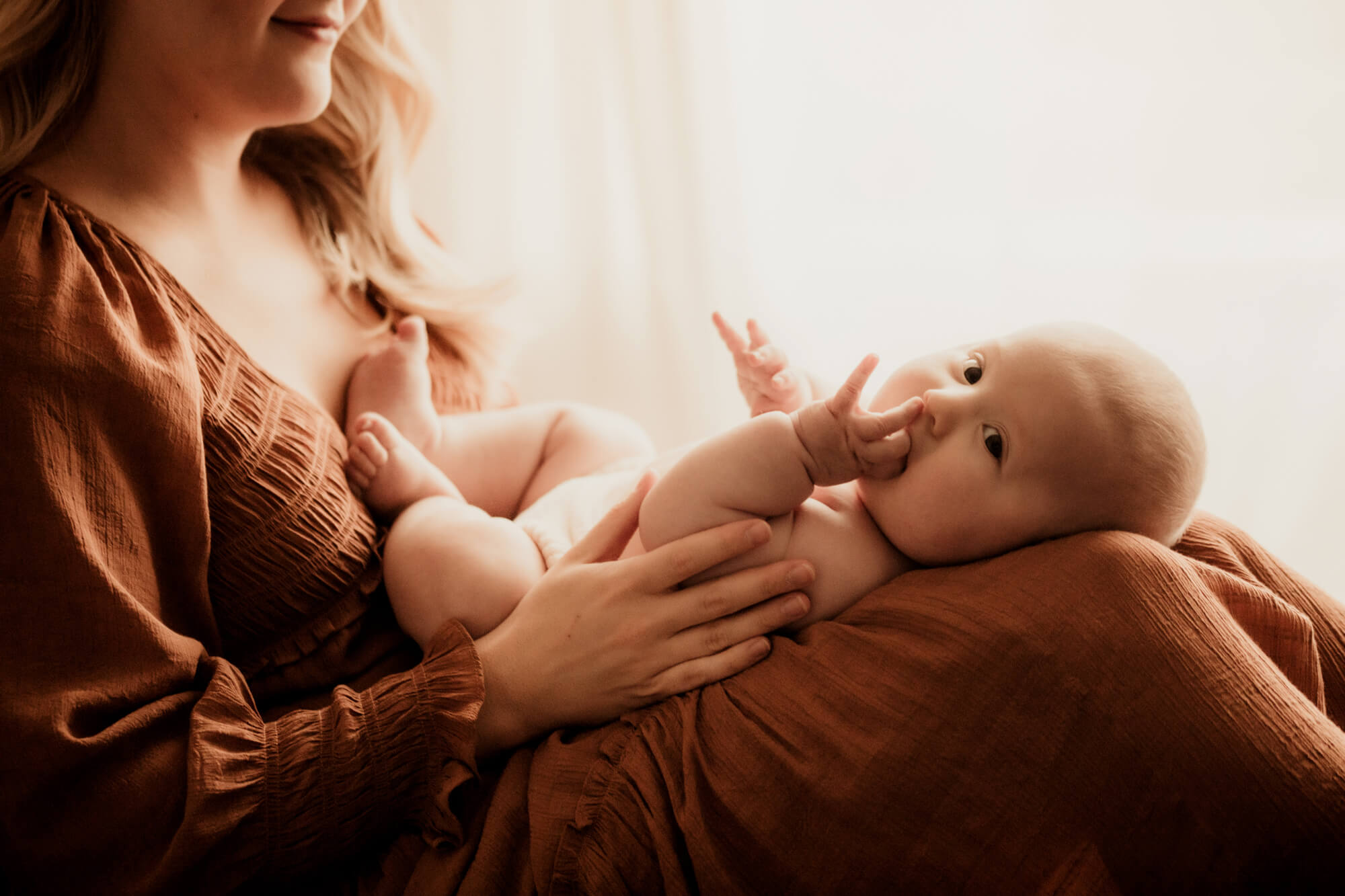 Baby boy laying on his mother's lap, Peek-A-Boo Baby