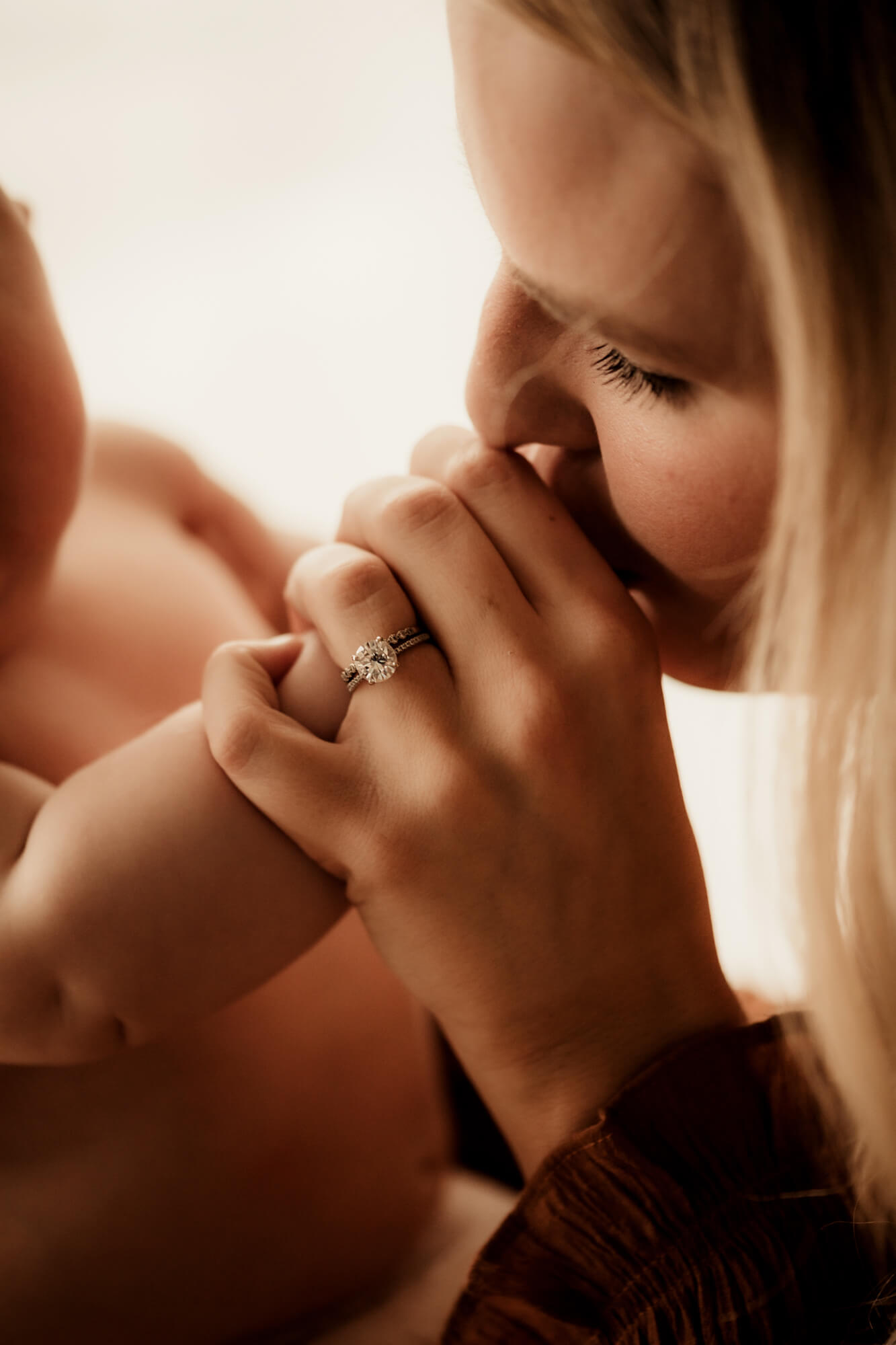 Mother kisses her son's hand