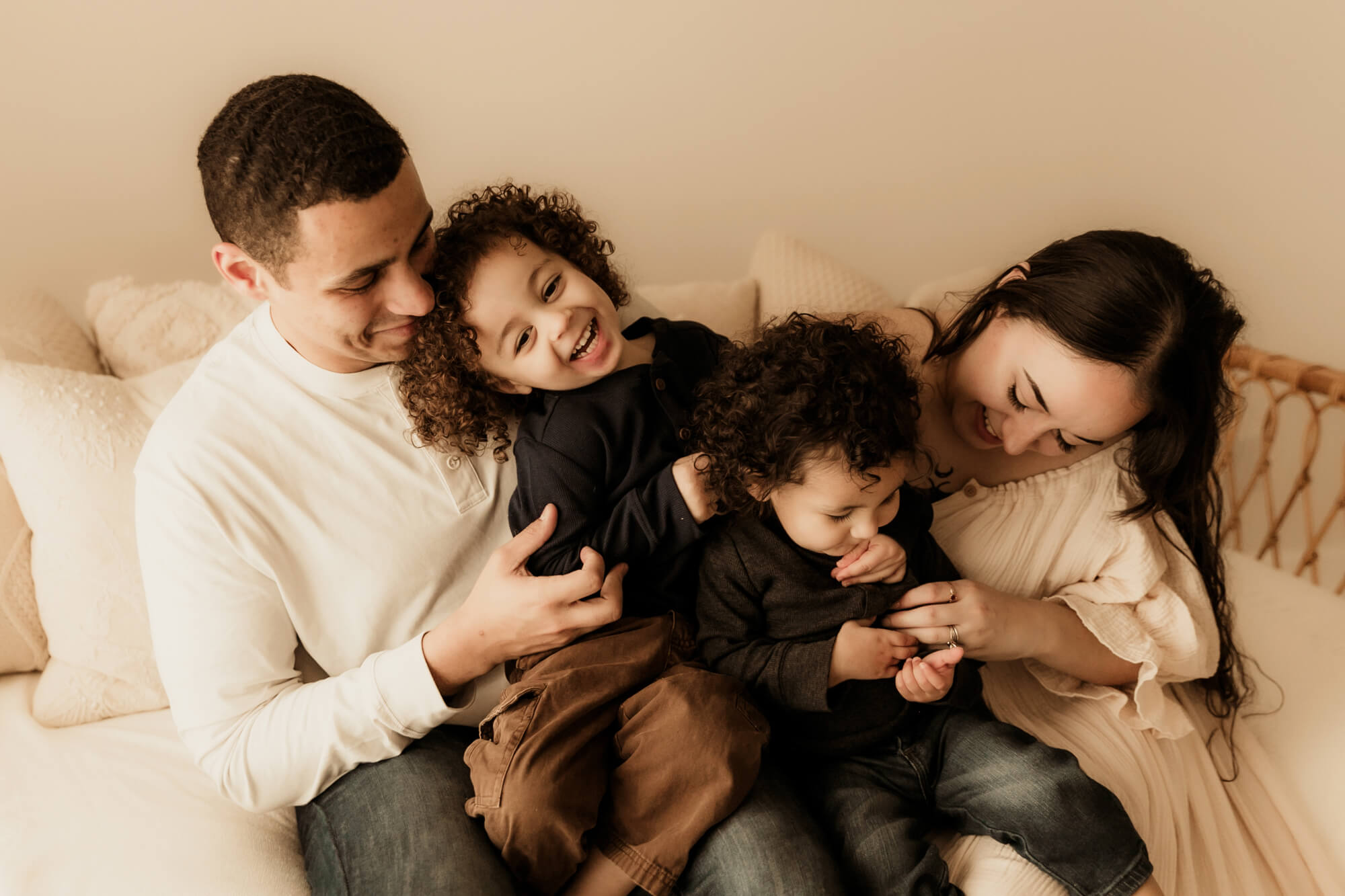 Family laughs while tickling one another