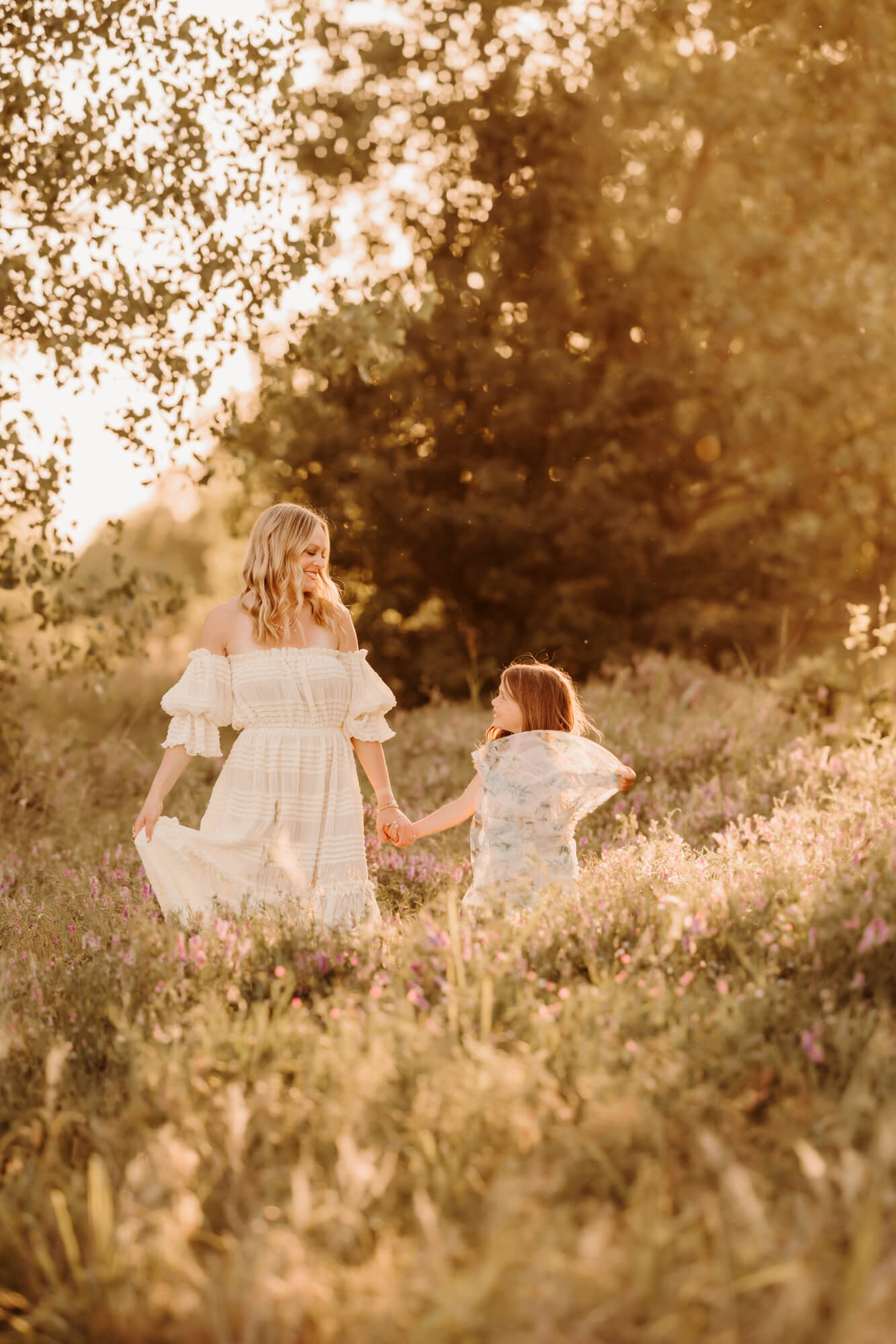 Mother and daughter dance and swish their dresses in a field, things to do with kids in Oklahoma City