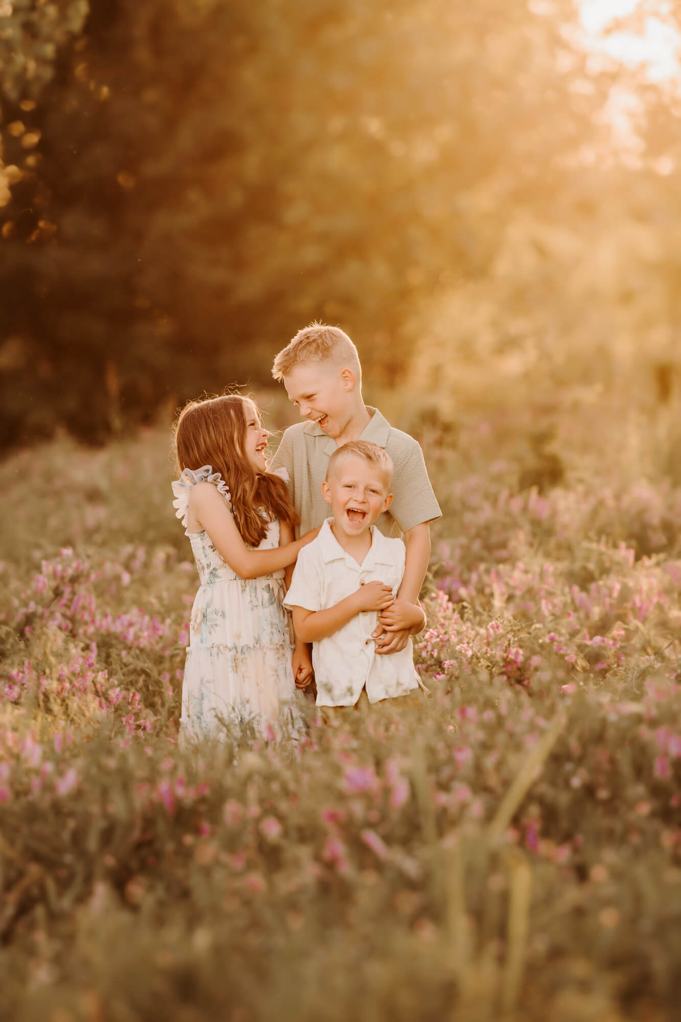 Two brothers laughing with their sister in a field, things to do with kids in Oklahoma City