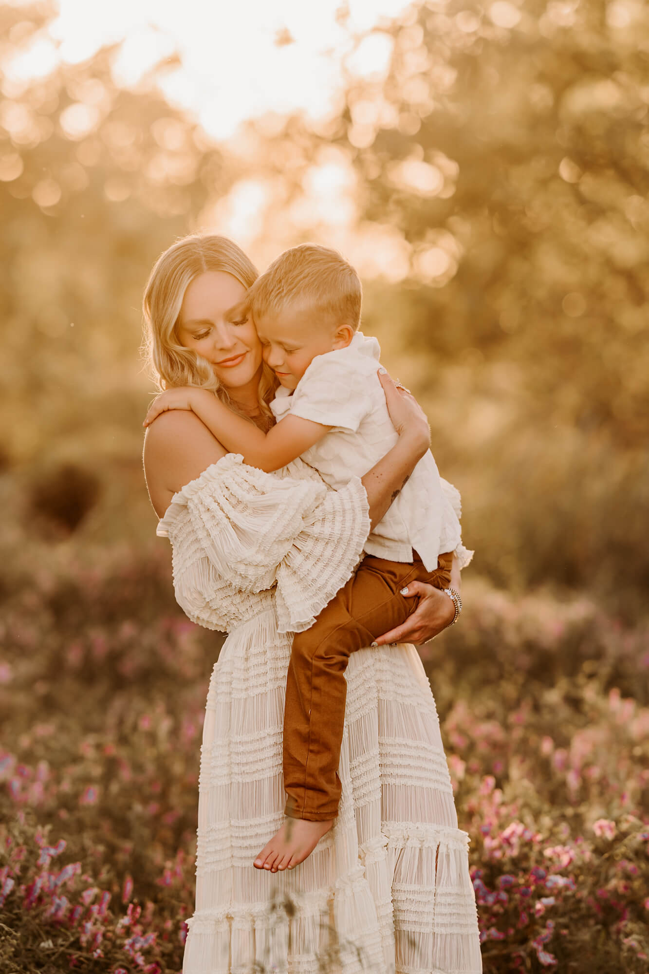 Mother and son snuggle one another in a field with purple flowers, things to do with kids in Oklahoma City