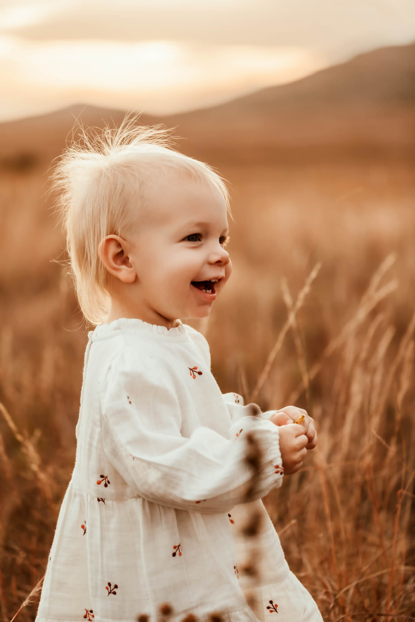 Profile image of a toddler girl wearing a white dress.